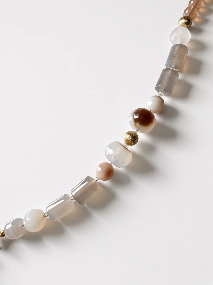 Hue La La Gems beaded statement necklace featuring natural agate beads in taupe, cream, and brown with gold accents.