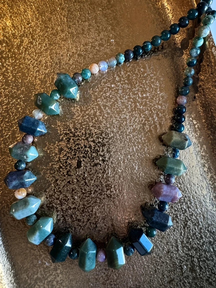 Hue La La Gems beaded necklace featuring faceted green and multi-colored agate stones on a textured gold surface.
