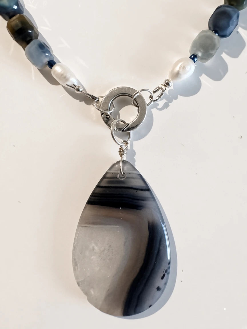 Hue La La Gems handcrafted statement necklace featuring a teardrop agate pendant, freshwater pearls, and cube beads.