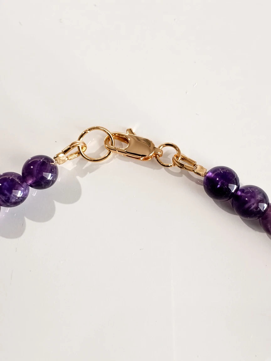Hue La La Gems amethyst beaded necklace featuring deep purple round beads and a polished gold-tone lobster clasp.