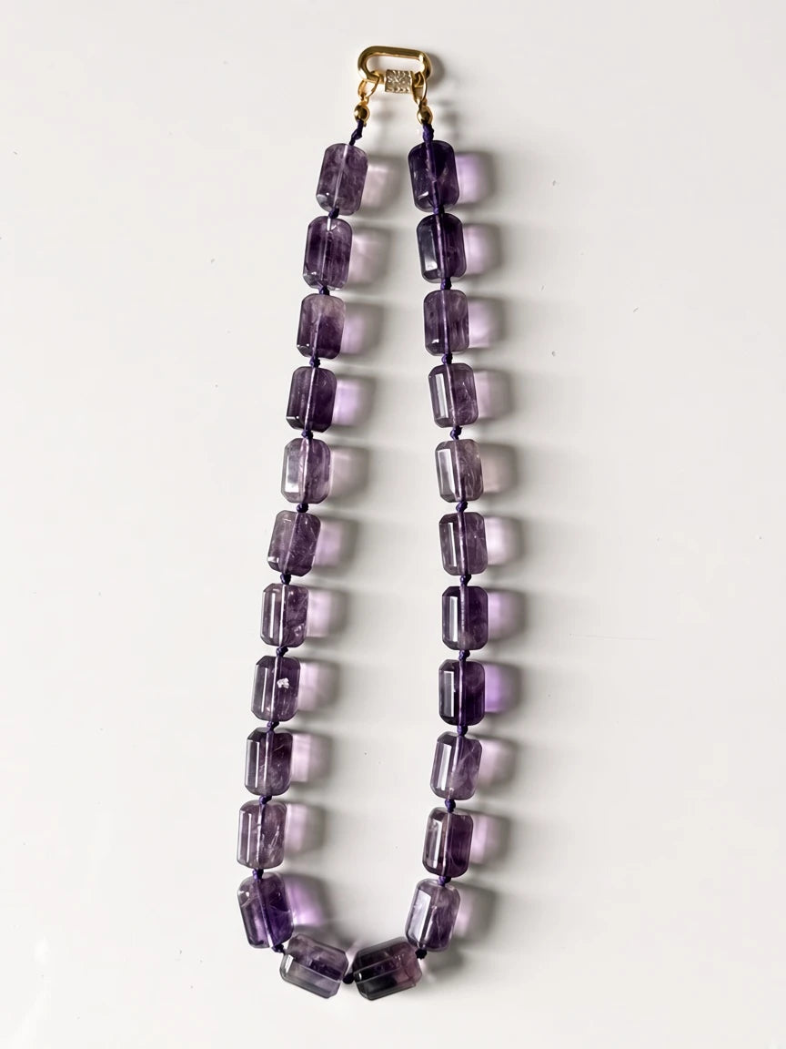 Hue La La Gems amethyst beaded statement necklace with rectangular purple stones on a knotted cord and gold clasp