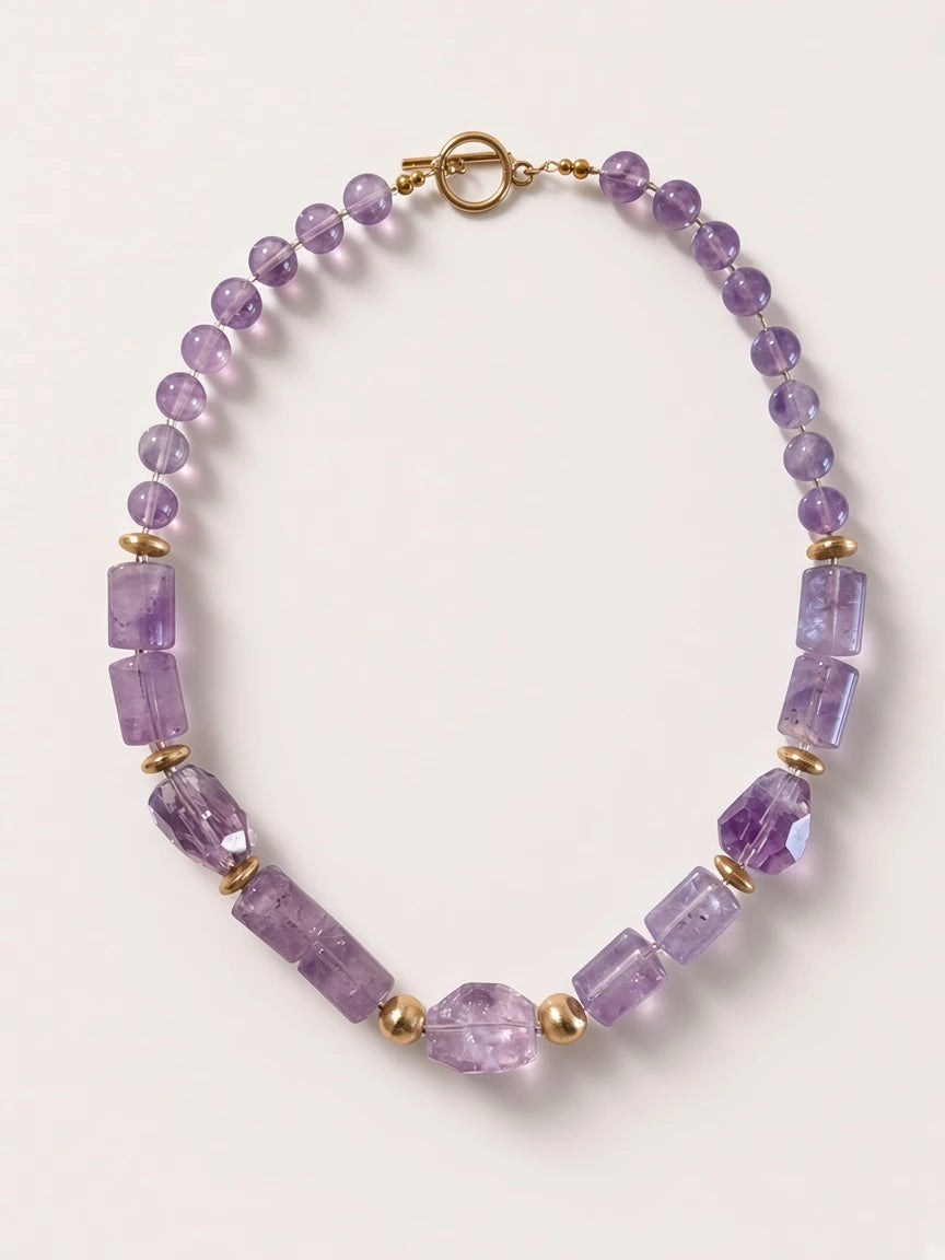 Hue La La Gems amethyst beaded statement necklace with gold-tone accents and a toggle clasp on a neutral background.