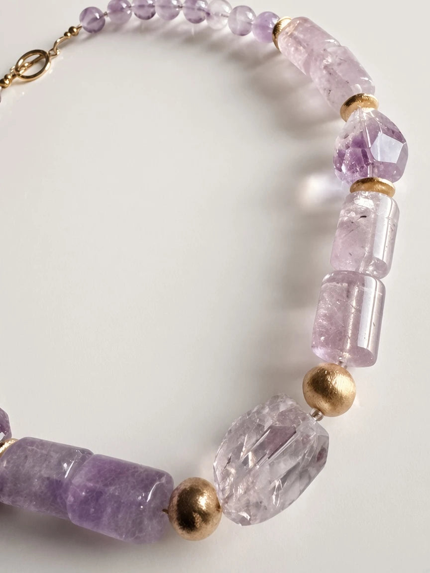 Hue La La Gems amethyst beaded statement necklace with faceted purple stones and polished gold-tone metal accents.