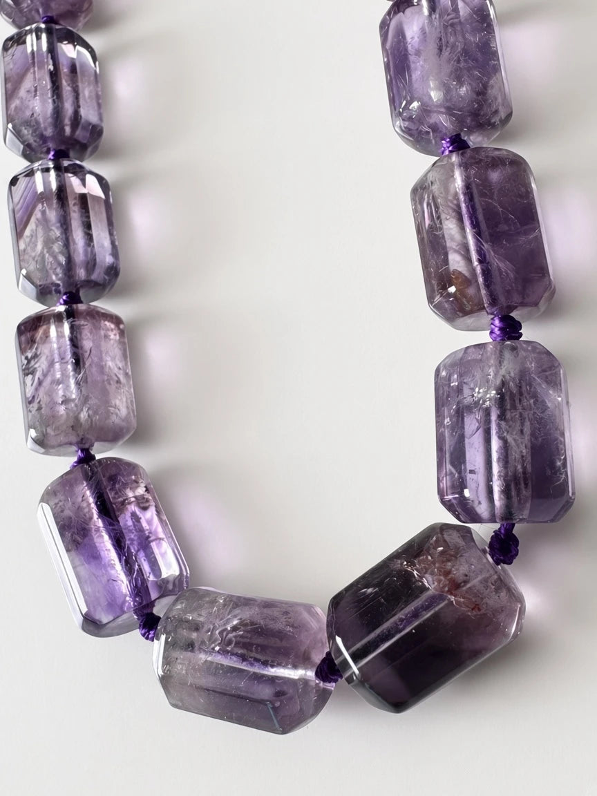 Hue La La Gems statement necklace featuring rectangular-cut purple amethyst beads hand-knotted on a purple cord.