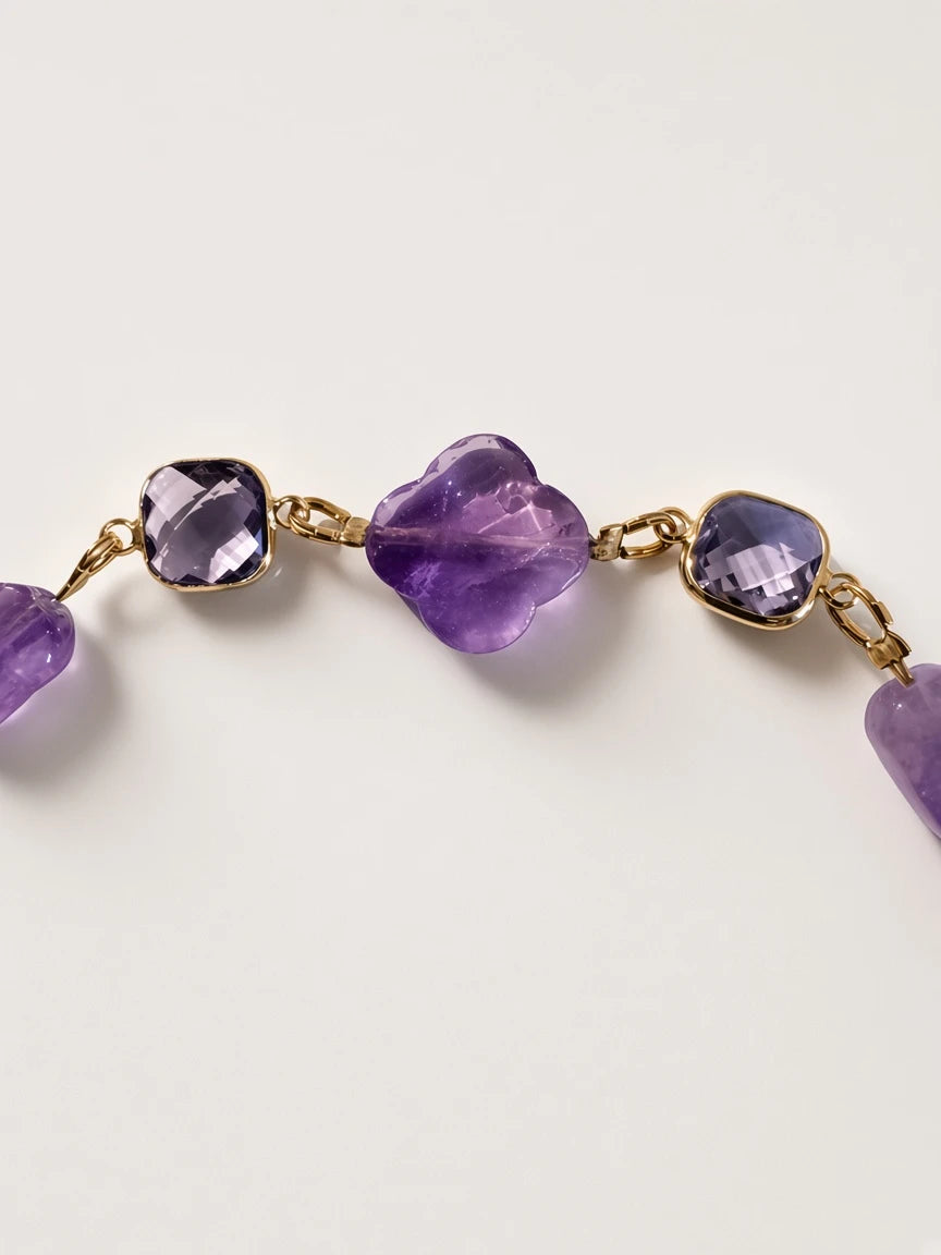 Hue La La Gems amethyst beaded necklace featuring faceted purple stones and clover-shaped accents with gold-tone links.