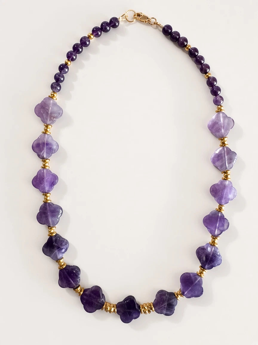 Hue La La Gems statement necklace featuring purple amethyst beads and clover-shaped stones with gold-tone spacers.