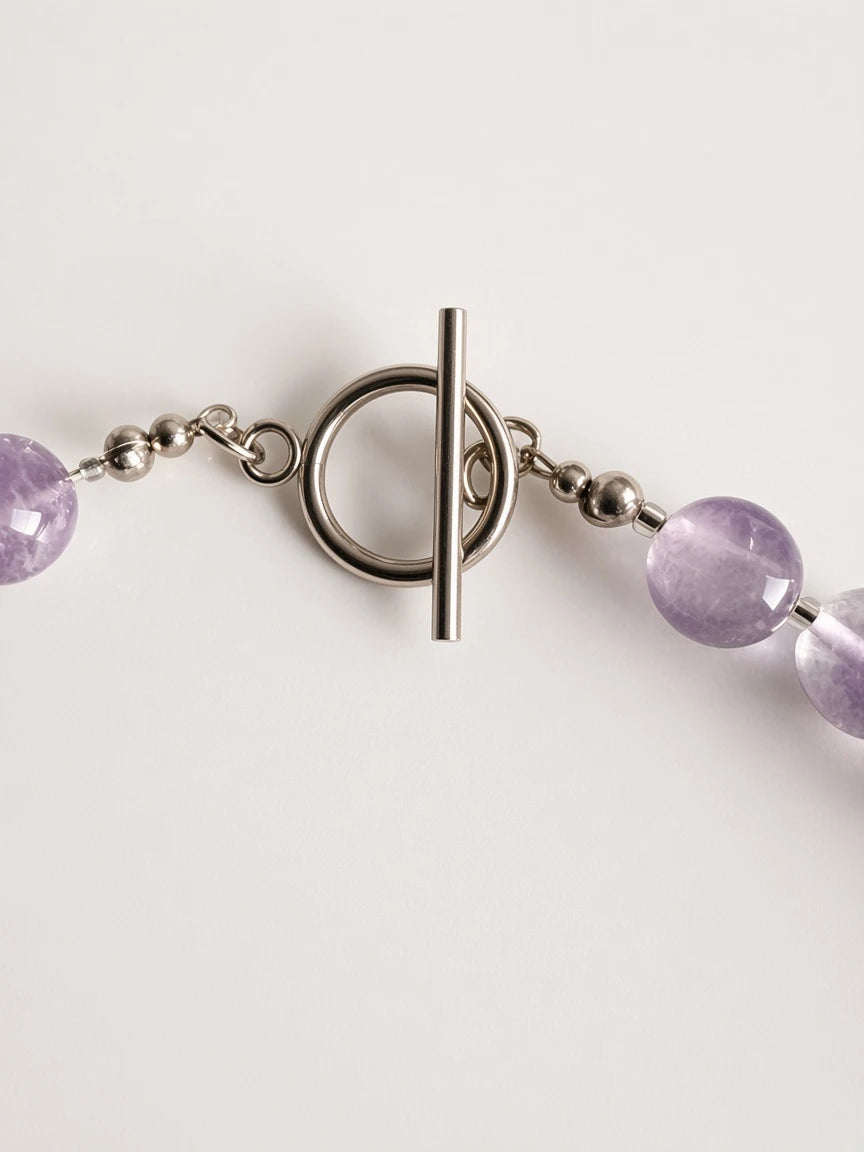 Hue La La Gems amethyst beaded necklace featuring a polished silver-tone toggle clasp and smooth purple gemstone beads.