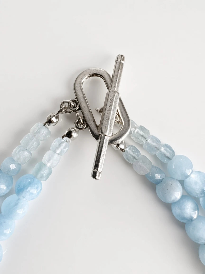 Hue La La Gems multi-strand statement necklace featuring faceted blue aquamarine beads and a silver-tone toggle clasp.