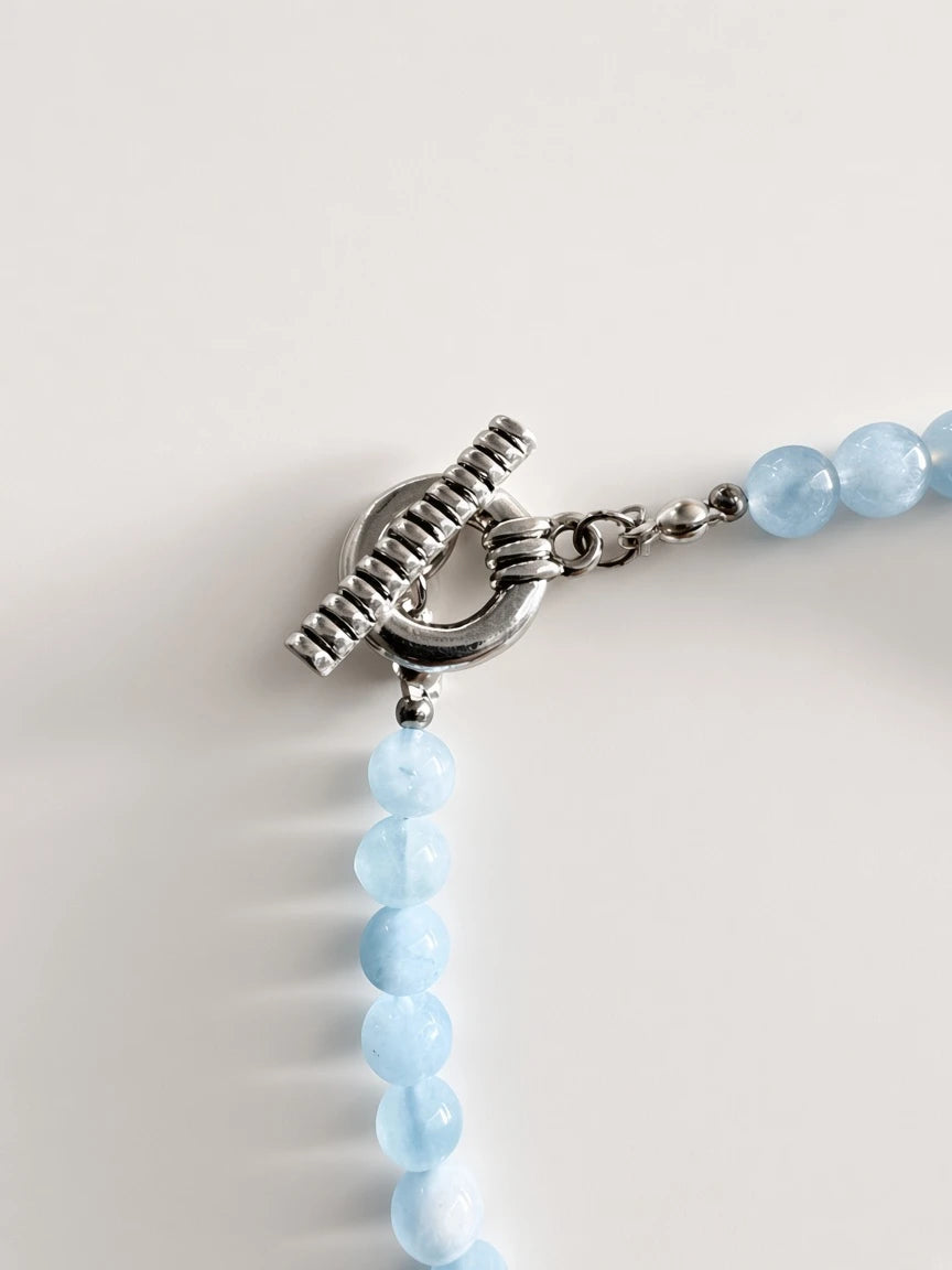 Hue La La Gems handcrafted statement necklace featuring light blue aquamarine beads and a silver-tone toggle clasp.