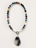 Hue La La Gems handcrafted statement necklace with multi-colored cube gemstone beads, freshwater pearls, and agate pendant