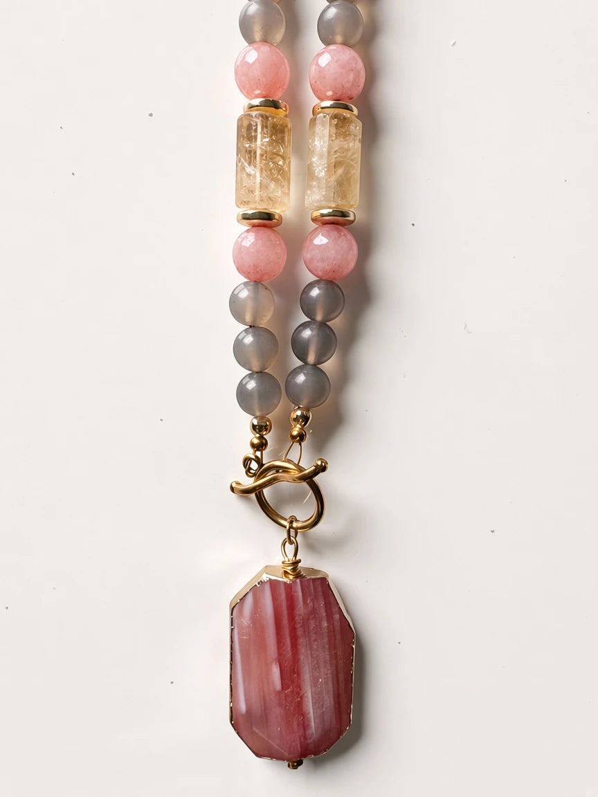 Hue La La Gems beaded statement necklace featuring pink, grey, and citrine gemstones with a gold-tone toggle clasp.