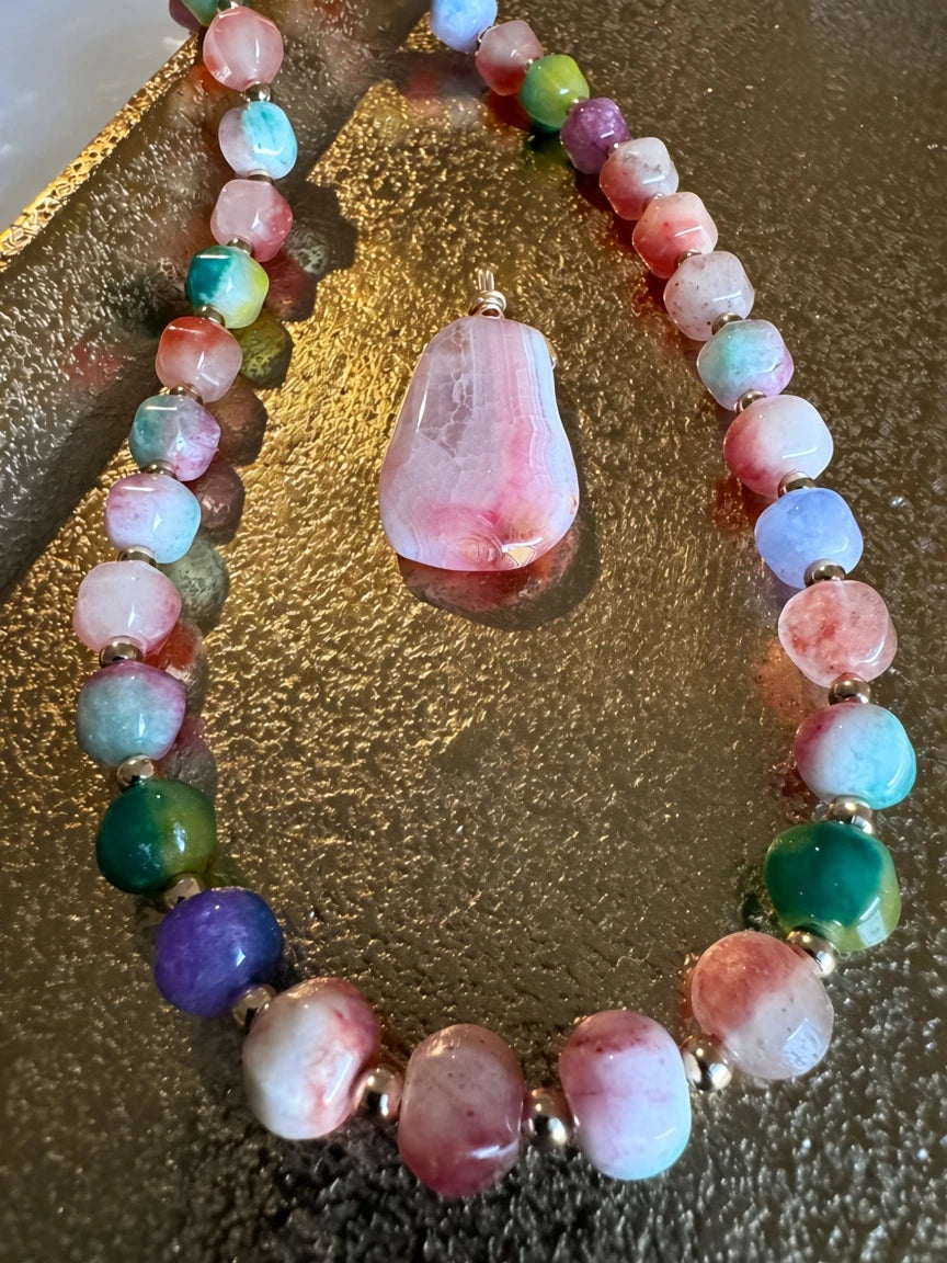 Hue La La Gems multi-colored gemstone beaded necklace with a large faceted pink stone pendant and gold-tone spacers.