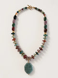 Hue La La Gems beaded statement necklace with multi-colored polished gemstones, gold-tone spacers, and a green pendant.
