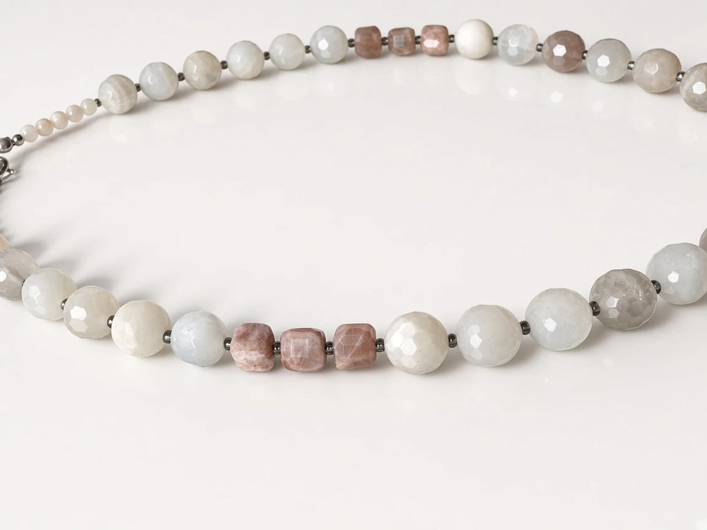 Hue La La Gems beaded statement necklace featuring faceted moonstone and sunstone beads in soft white and dusty rose.