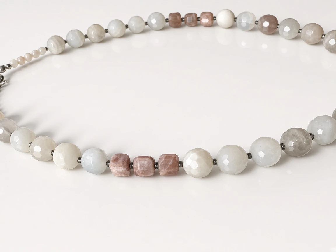 Hue La La Gems beaded statement necklace featuring faceted moonstone and sunstone beads in soft white and dusty rose.
