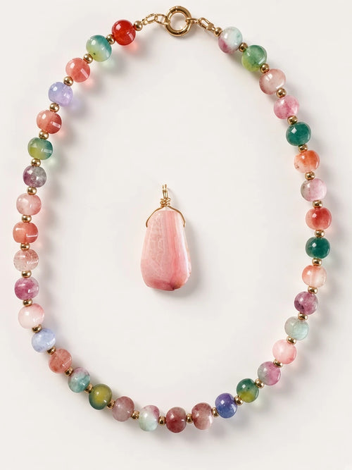 Hue La La Gems multi-colored gemstone beaded necklace with a large faceted pink stone pendant and gold-tone spacers.