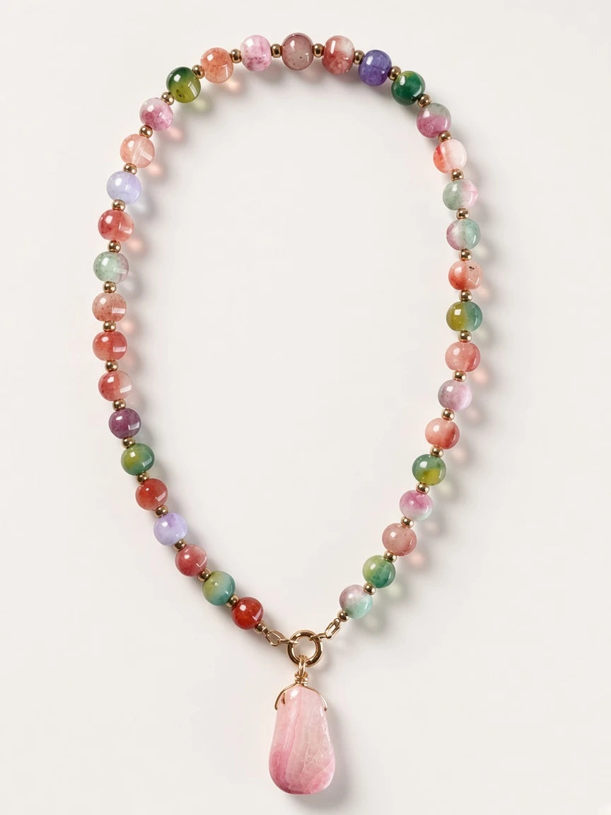 Hue La La Gems multi-colored gemstone beaded necklace with a large faceted pink stone pendant and gold-tone spacers.