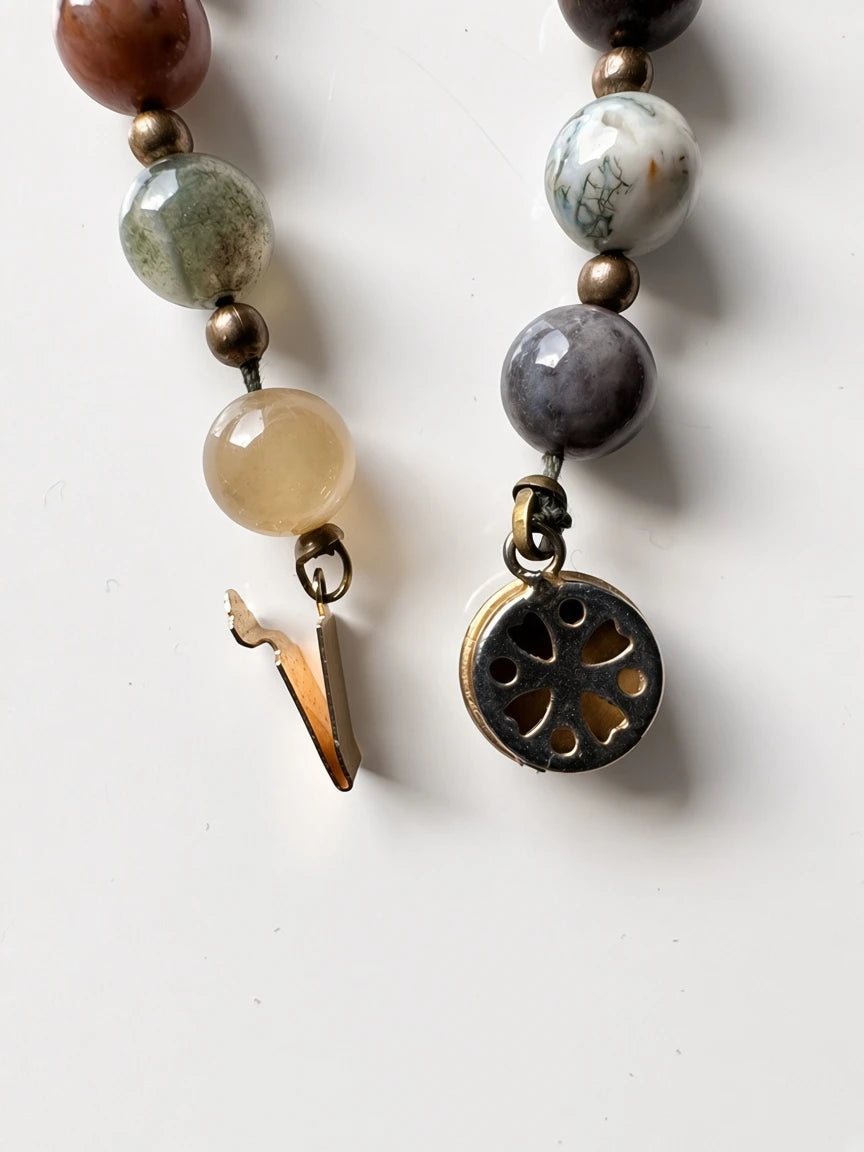 Hue La La Gems mala necklace featuring natural gemstone beads in earthy tones with a vintage-inspired gold clasp