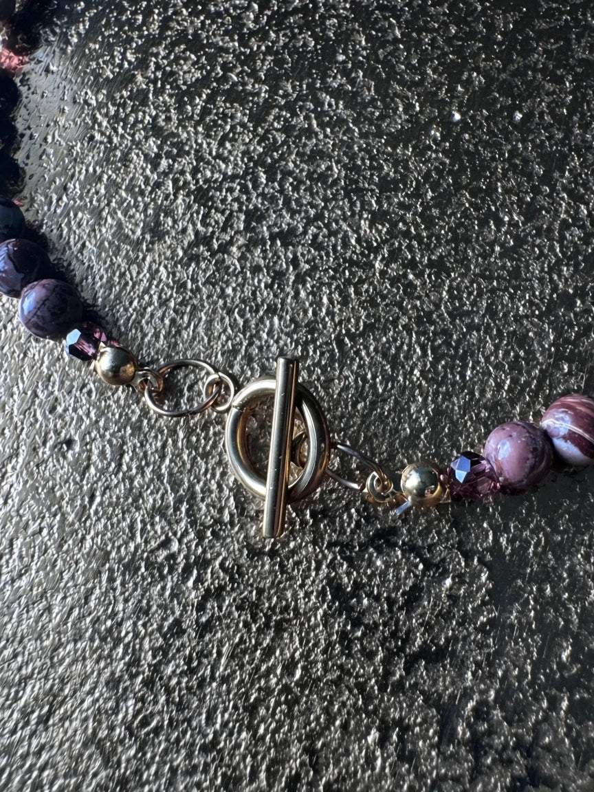 Hue La La Gems statement necklace featuring mauve natural stone beads, faceted crystals, and a gold-tone toggle clasp.