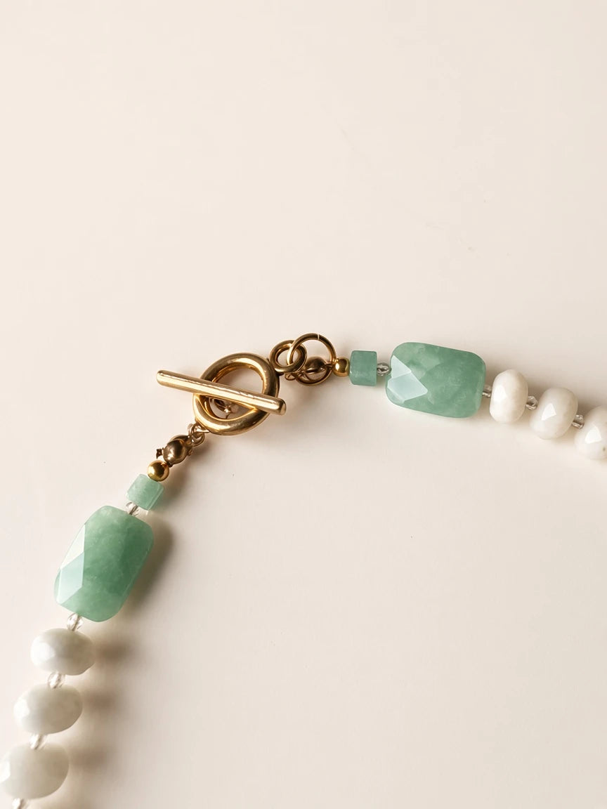 Hue La La Gems beaded necklace featuring faceted white beads, rectangular green gemstones, and a gold-tone toggle clasp.