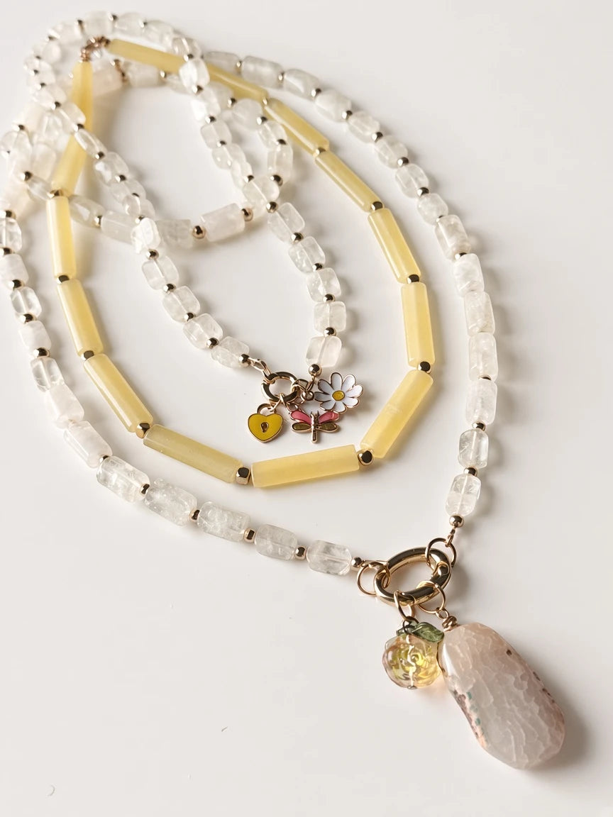 Hue La La Gems beaded statement necklace with clear quartz, yellow beads, gold spacers, and floral charm pendant.