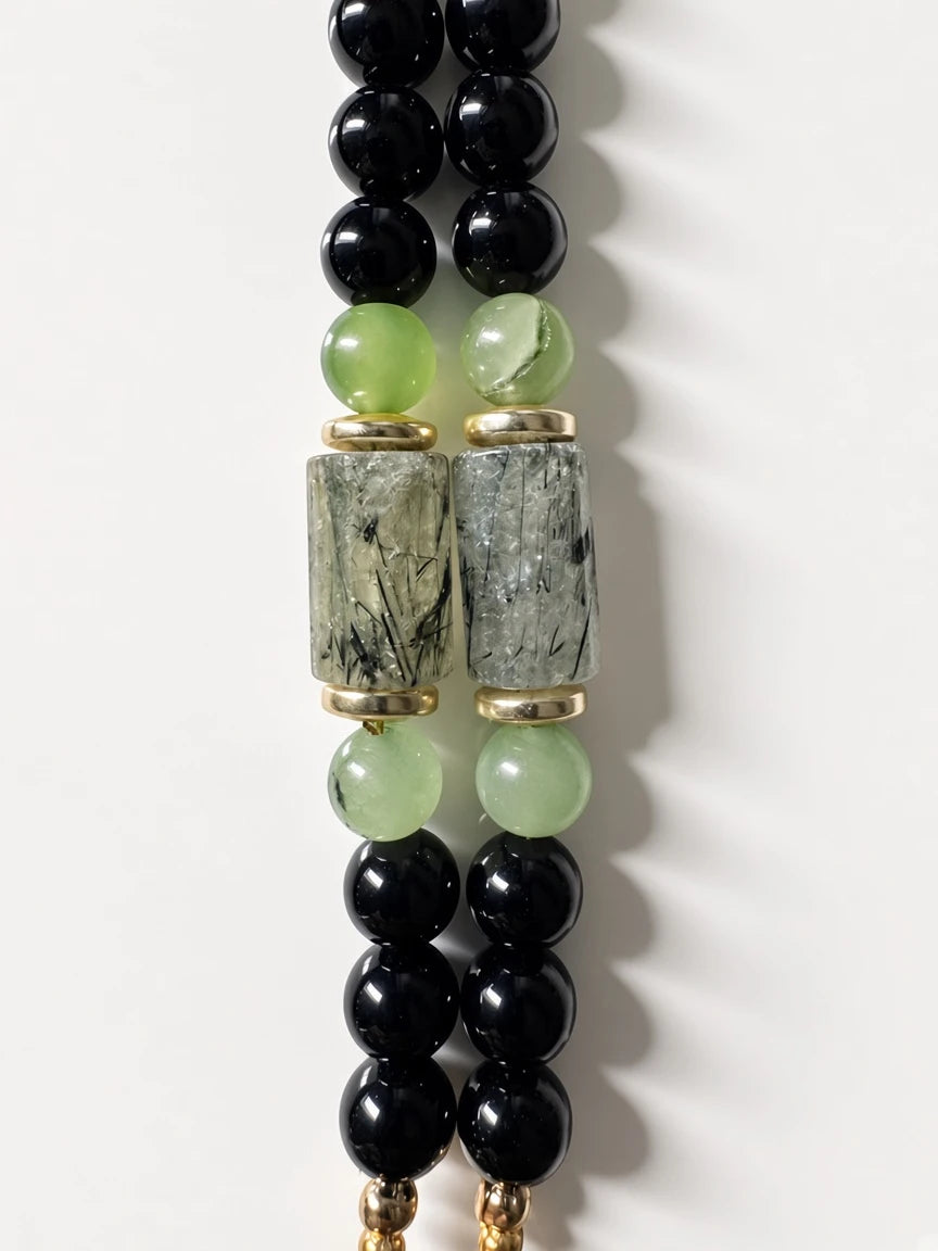 Hue La La Gems beaded necklace featuring polished black beads, green semi-precious stones, and rutilated quartz accents.