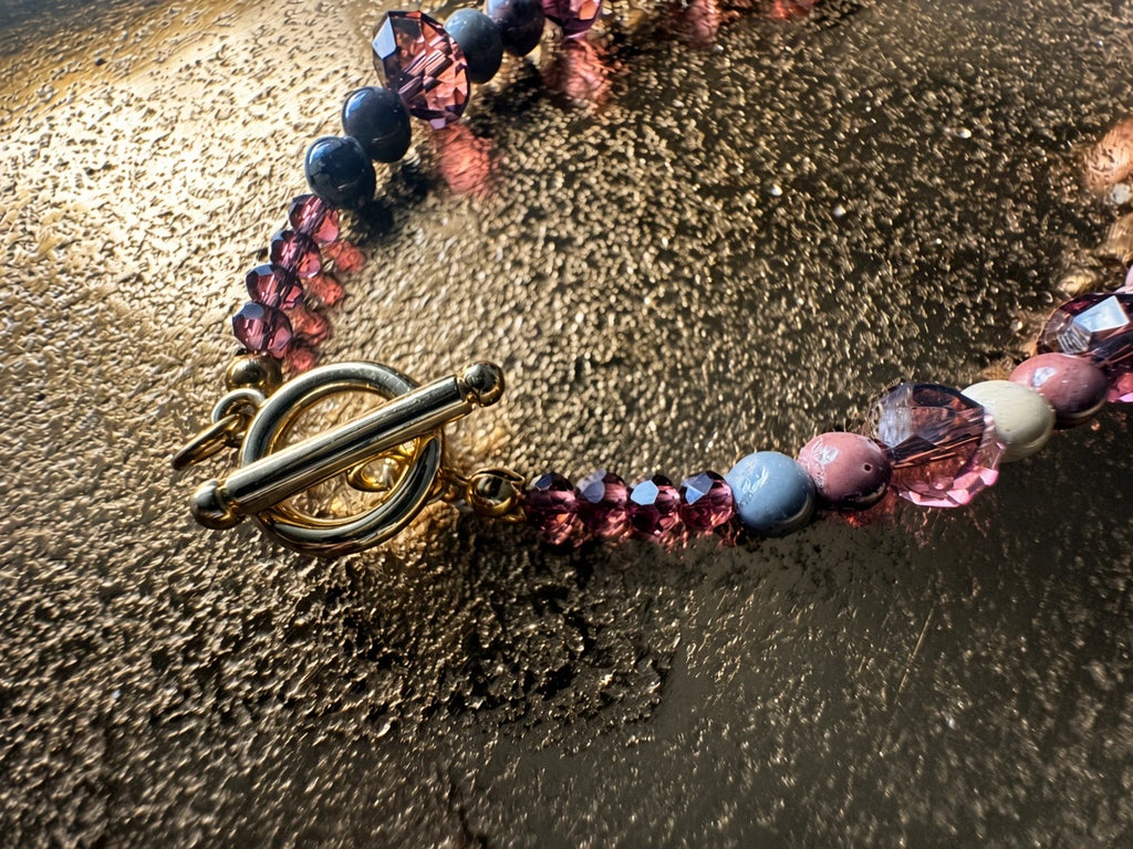 Hue La La Gems statement necklace featuring plum, mauve, and slate stone beads with purple crystals and gold toggle clasp