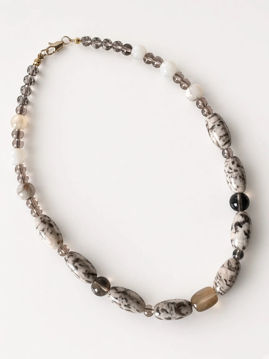 Hue La La Gems statement necklace featuring marbled stone, smoky quartz, and creamy beads on a neutral string.