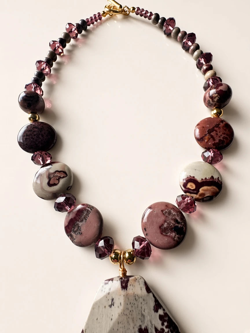 Hue La La Gems statement necklace featuring plum and grey stone beads, faceted purple crystals, and a gold toggle clasp