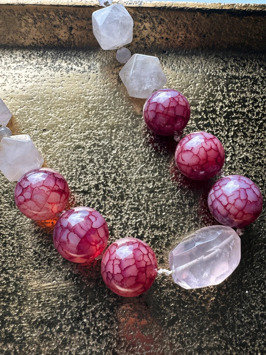 Hue La La Gems statement necklace featuring faceted rose quartz and crackled berry-toned agate beads on a gold tray.