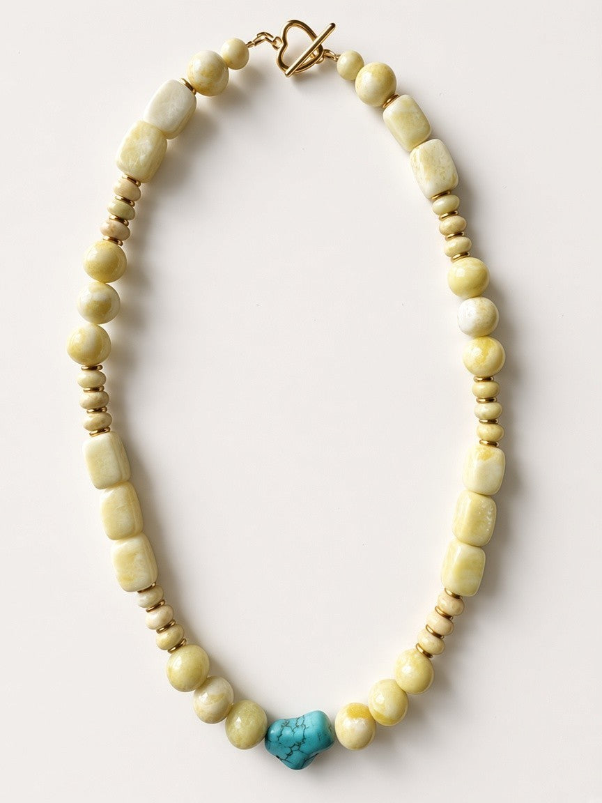 Hue La La Gems statement necklace with honey-toned gemstone beads, gold-tone spacers, and a central turquoise stone.