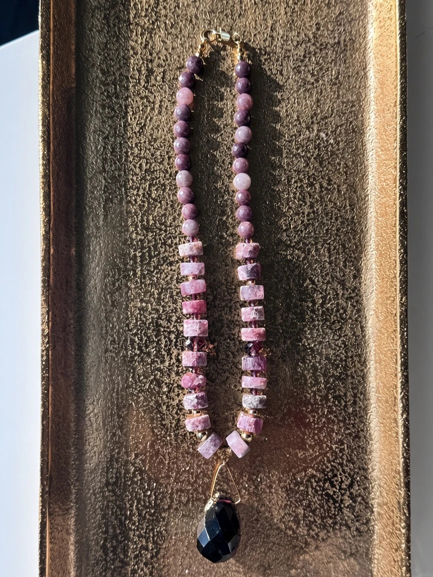 Hue La La Gems beaded statement necklace featuring plum and rose stone beads with a faceted dark purple crystal pendant
