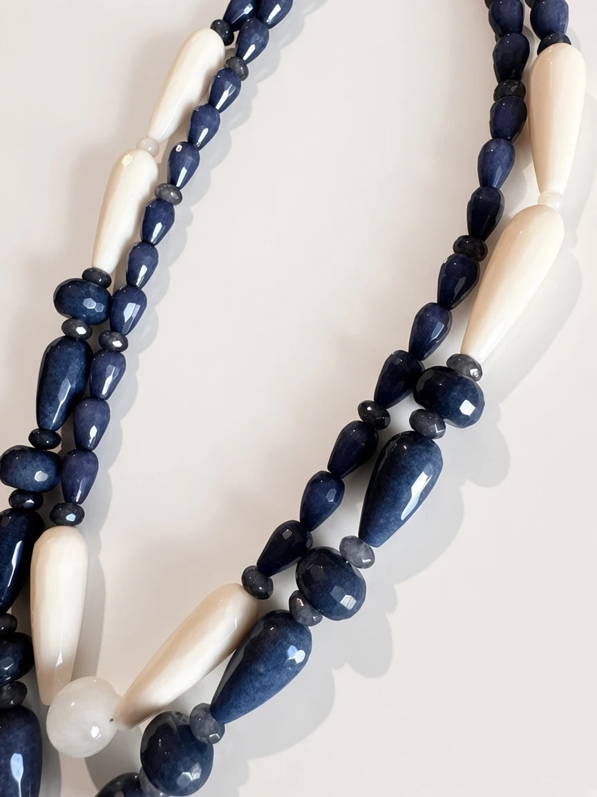 Hue La La Gems artisan beaded statement necklace set featuring navy blue and cream stone beads with teardrop shapes.