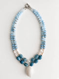 Hue La La Gems multi-strand statement necklace with blue aquamarine beads, freshwater pearls, and a shell pendant.