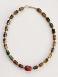 Hue La La Gems statement necklace featuring cylindrical multi-colored gemstone beads and polished gold-tone spacers.