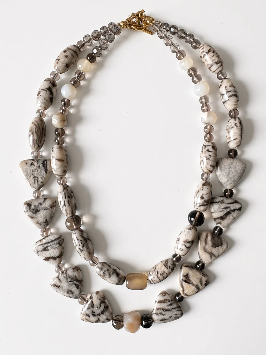 Hue La La Gems multi-strand statement necklace featuring marbled stone, smoky quartz, and creamy beads on white background
