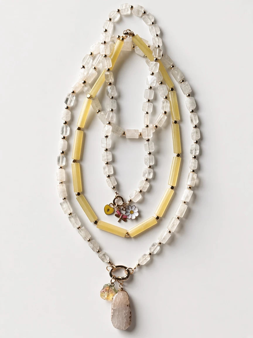 Hue La La Gems beaded statement necklace with clear quartz, yellow beads, gold spacers, and a floral charm pendant.