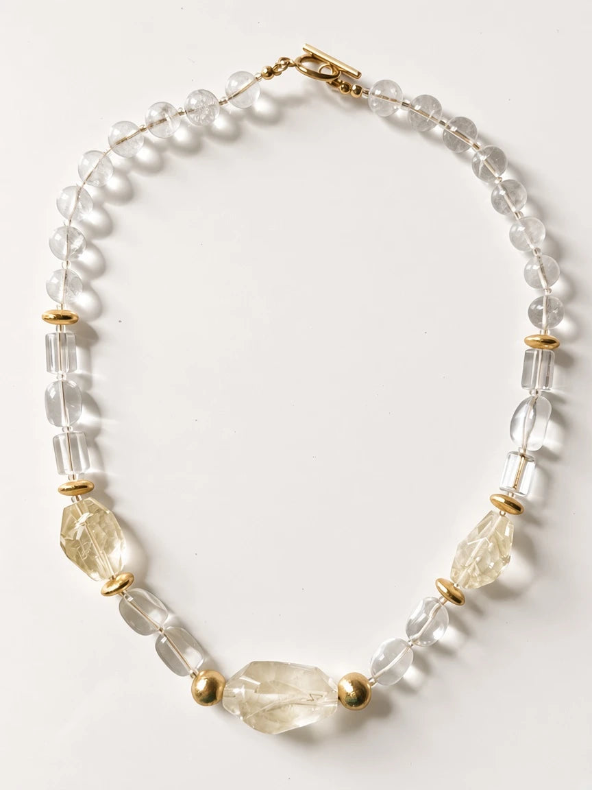 Hue La La Gems statement necklace featuring clear faceted beads and polished gold-tone metal accents with toggle clasp