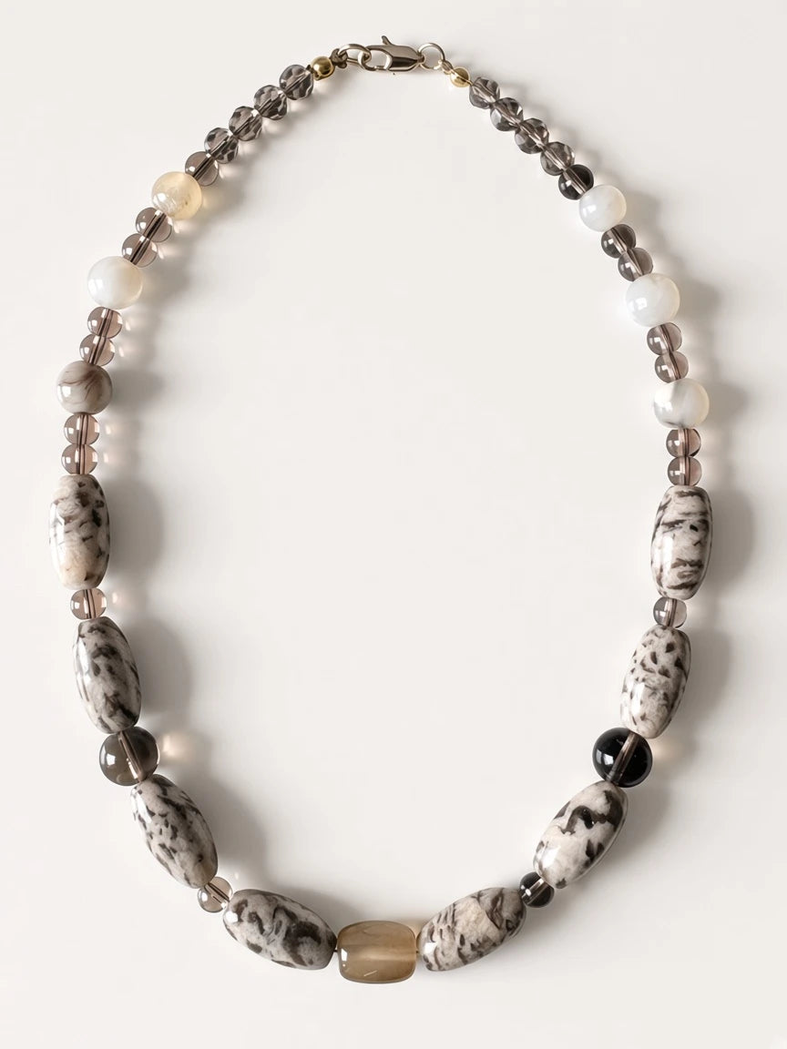 Hue La La Gems statement necklace featuring marbled stone, smoky quartz, and creamy beads in a neutral earthy palette.
