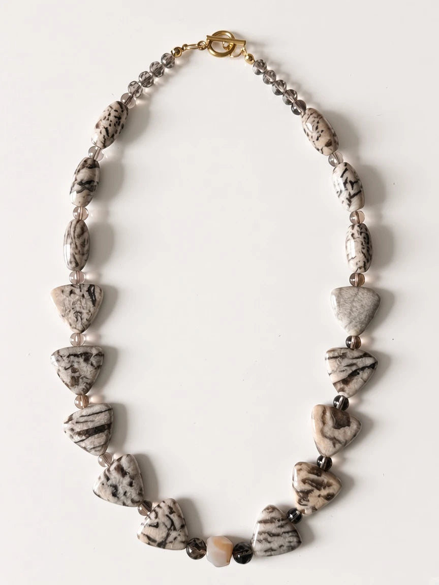 Hue La La Gems artisan statement necklace with patterned jasper-style stone beads and a gold toggle clasp.