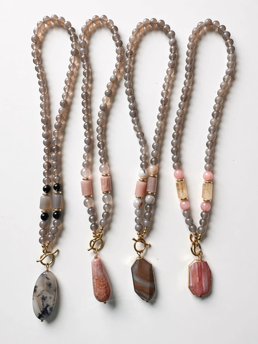 Hue La La Gems handcrafted beaded statement necklaces with grey agate, pink stone, and citrine accents on gold toggles.