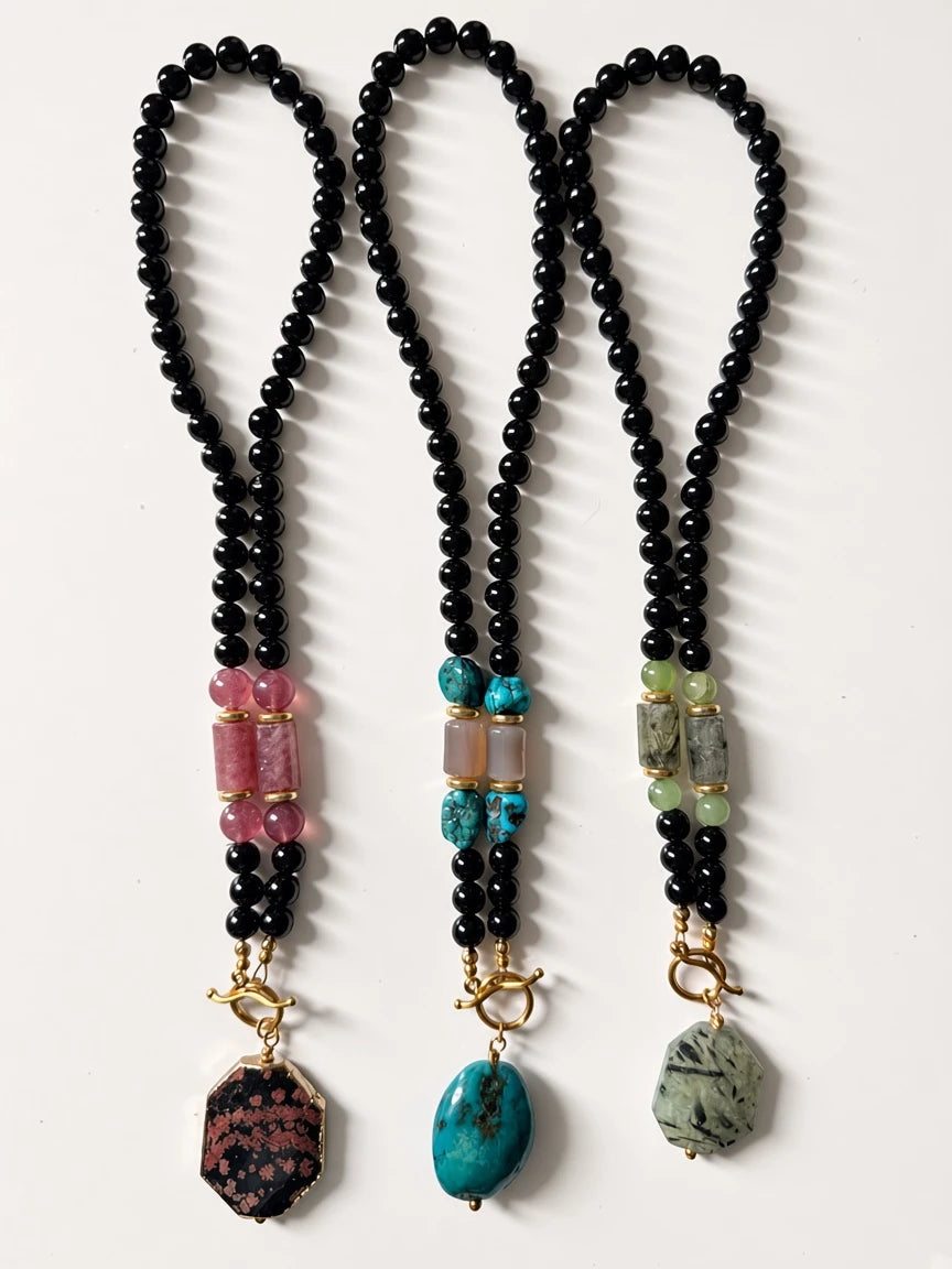 Hue La La Gems beaded statement necklaces featuring black beads, semi-precious stones, and gold-tone toggle clasps.