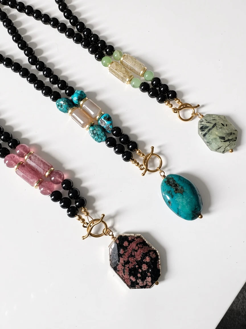 Hue La La Gems beaded statement necklaces featuring black beads, semi-precious stones, and gold-tone toggle clasps.