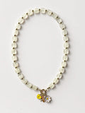 Hue La La Gems beaded necklace with translucent square stones, gold spacers, and yellow heart and daisy charms.