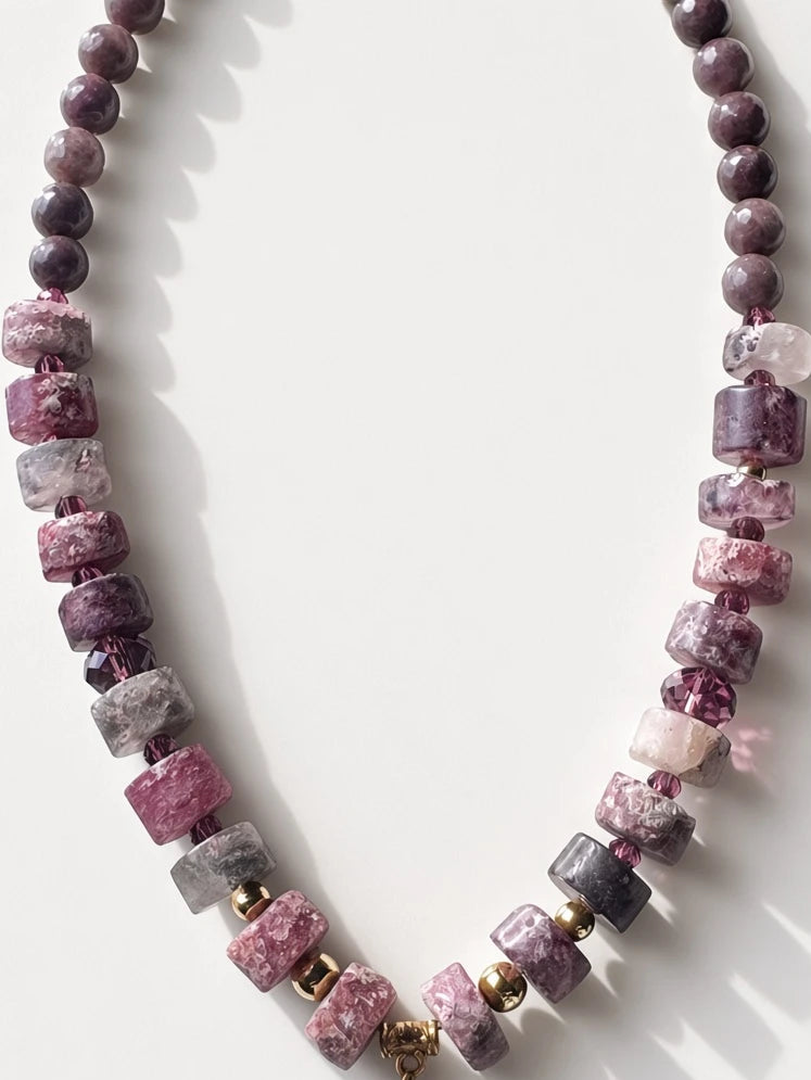 Hue La La Gems beaded statement necklace featuring plum and mauve stone beads with a purple silk tassel pendant.