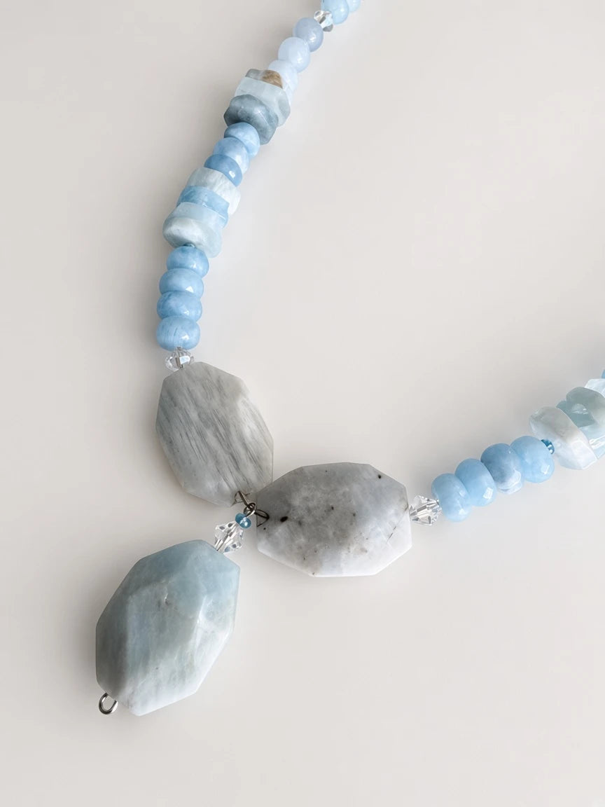 Hue La La Gems handcrafted statement necklace with blue aquamarine beads, geometric stones, and clear crystal spacers.