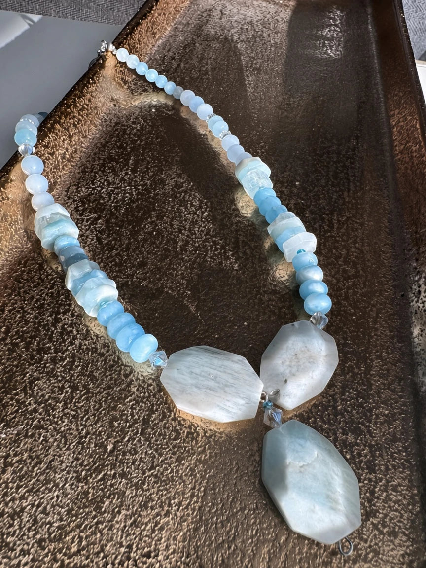 Hue La La Gems handcrafted statement necklace with blue aquamarine beads, crystal spacers, and geometric stone pendants