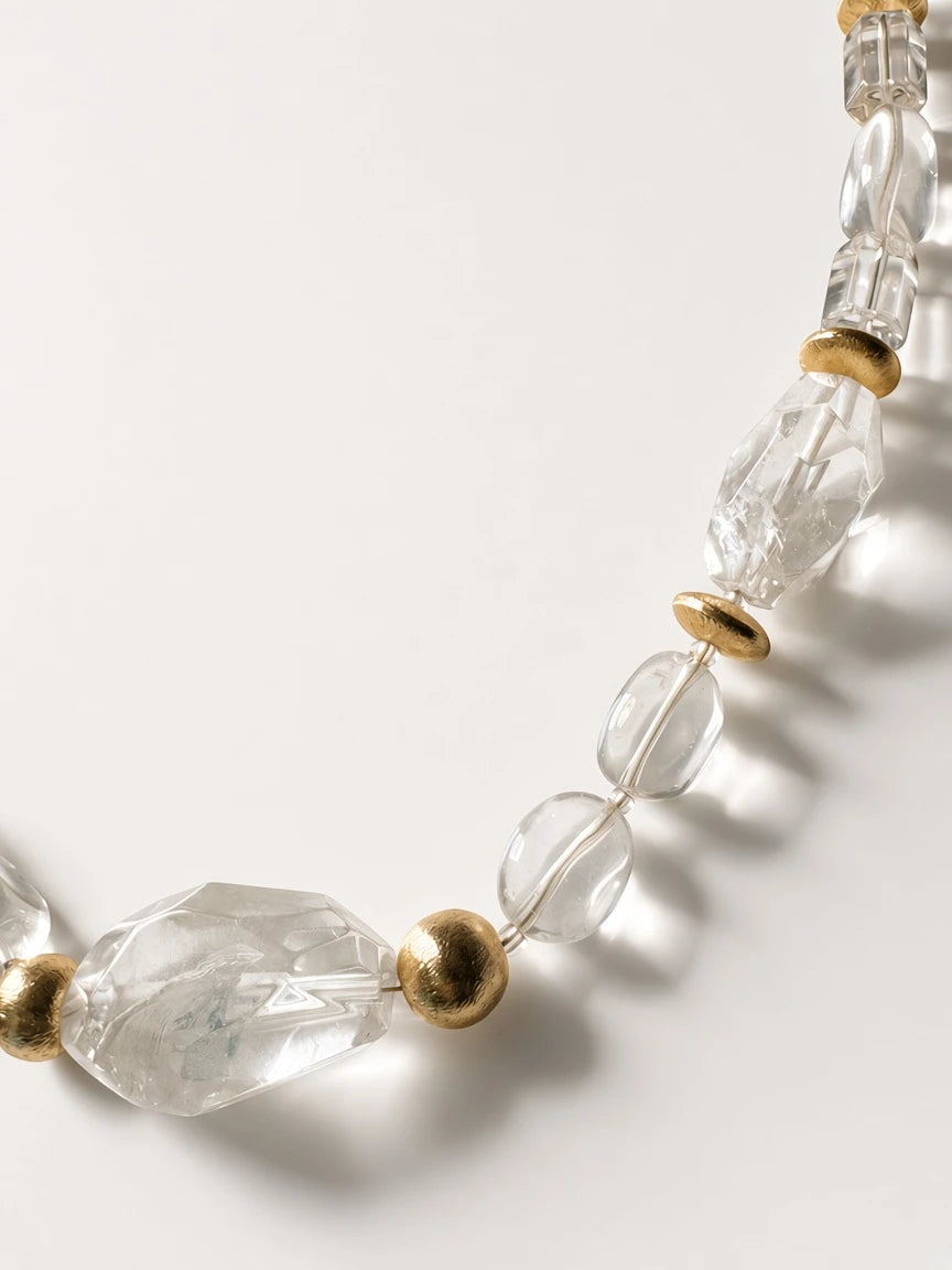 Hue La La Gems statement necklace featuring faceted clear crystal-like beads and polished gold-tone metal accents