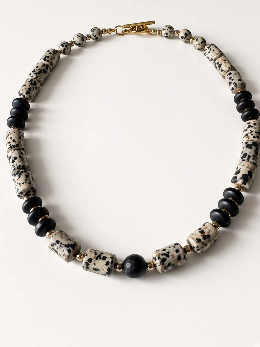 Hue La La Gems statement necklace featuring dalmatian jasper and matte black beads with gold-tone spacers and toggle