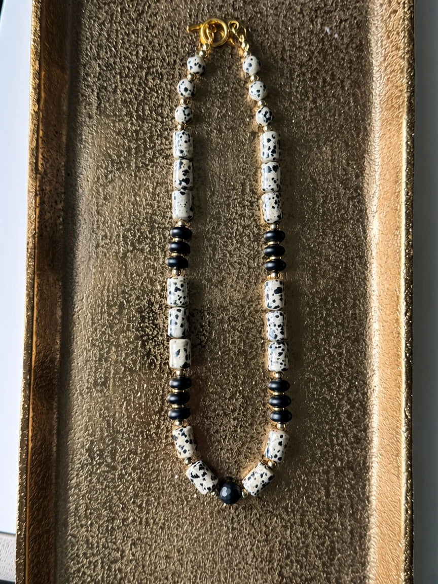 Hue La La Gems beaded statement necklace featuring dalmatian jasper and matte black beads with gold-tone spacers